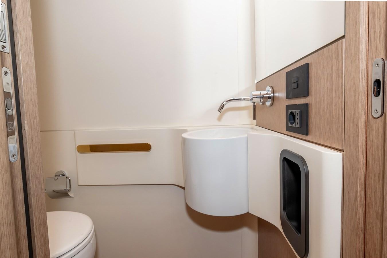 a small bathroom with a toilet aboard AZIMUT GRANDE 26/25 Yacht for Sale