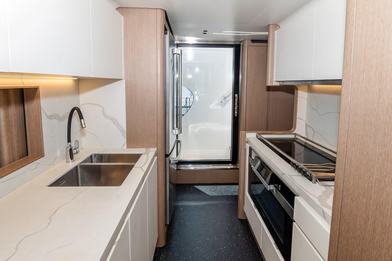 a kitchen with a sink and refrigerator aboard AZIMUT GRANDE 26/25 Yacht for Sale