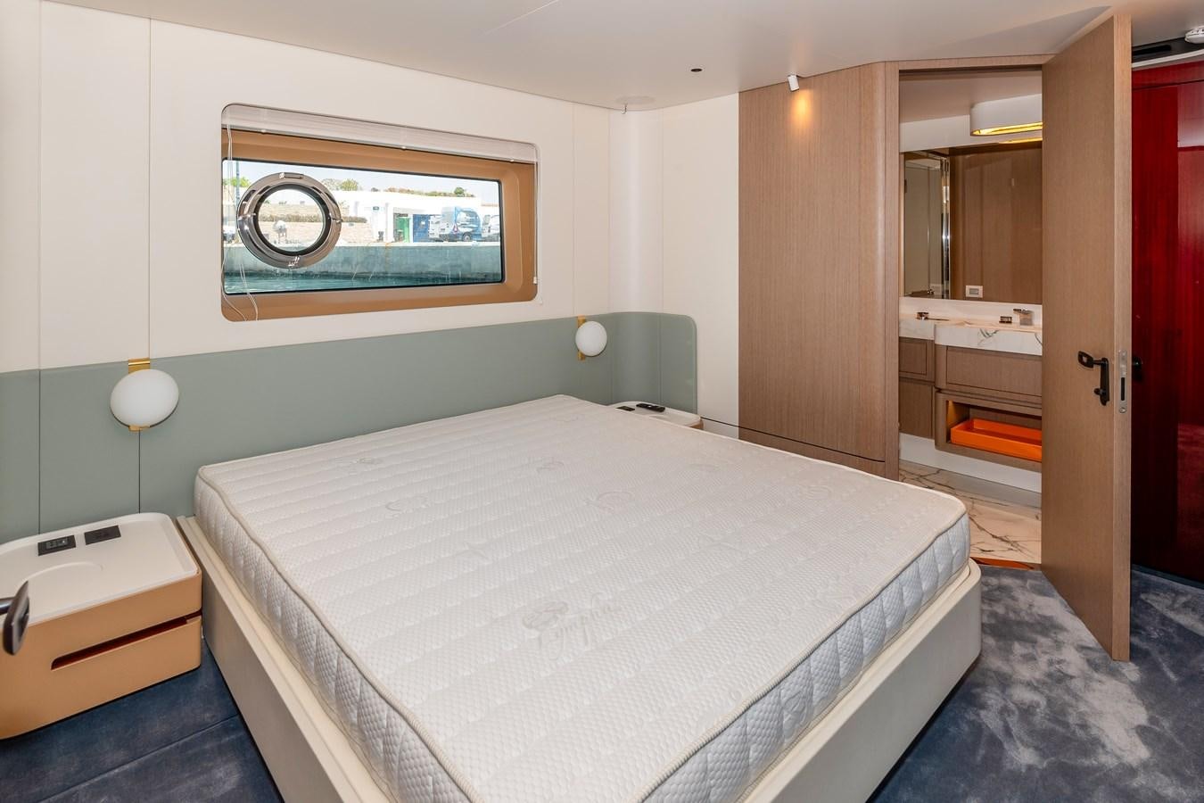 a bedroom with a bed and a mirror aboard AZIMUT GRANDE 26/25 Yacht for Sale