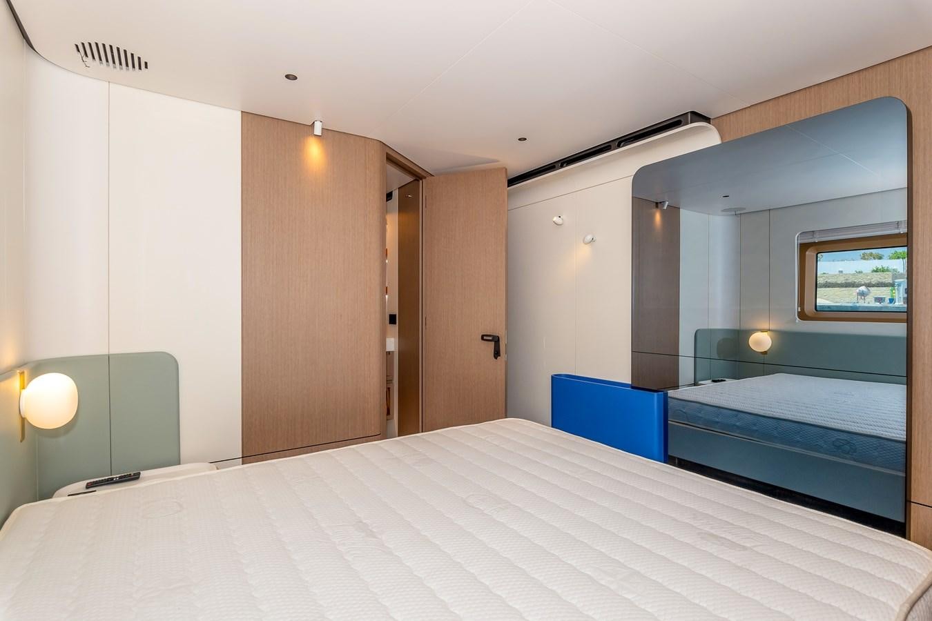 a room with a bed and a mirror aboard AZIMUT GRANDE 26/25 Yacht for Sale