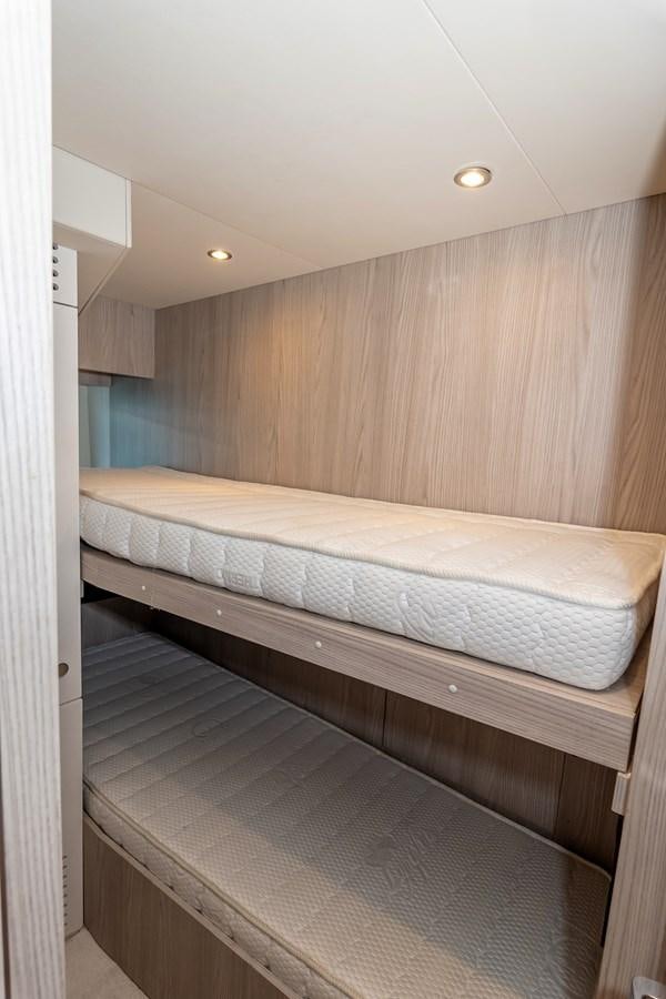a room with a bed and a wood wall aboard AZIMUT GRANDE 26/25 Yacht for Sale