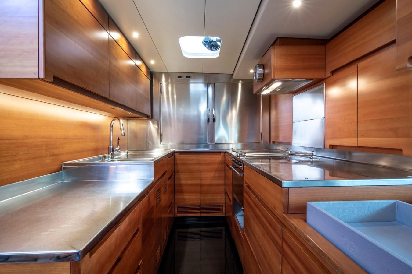 a kitchen with wooden cabinets aboard GALMA Yacht for Sale