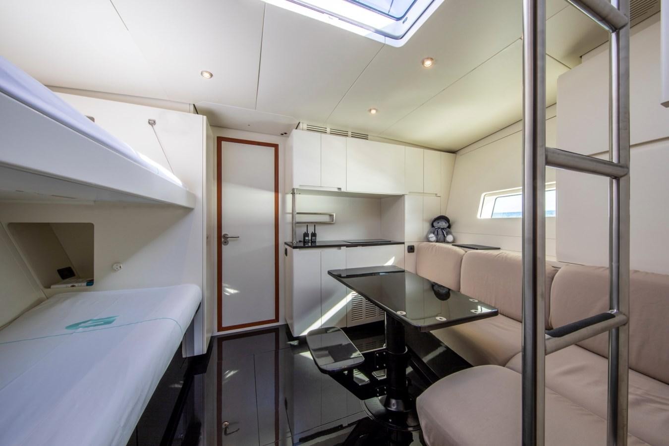 a room with a bed and desk aboard GALMA Yacht for Sale