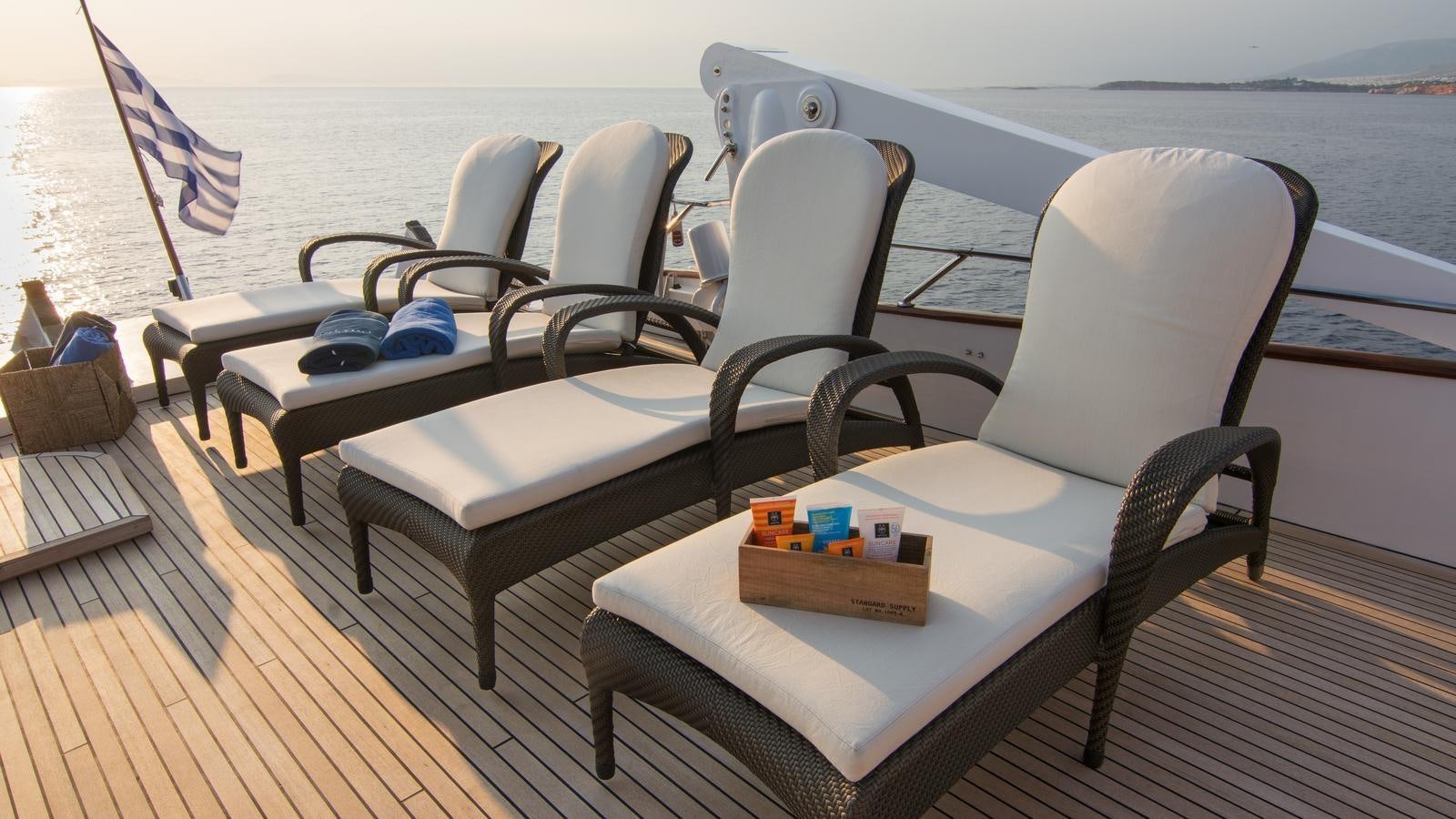 a couple of chairs on a deck aboard OCEANE II Yacht for Sale