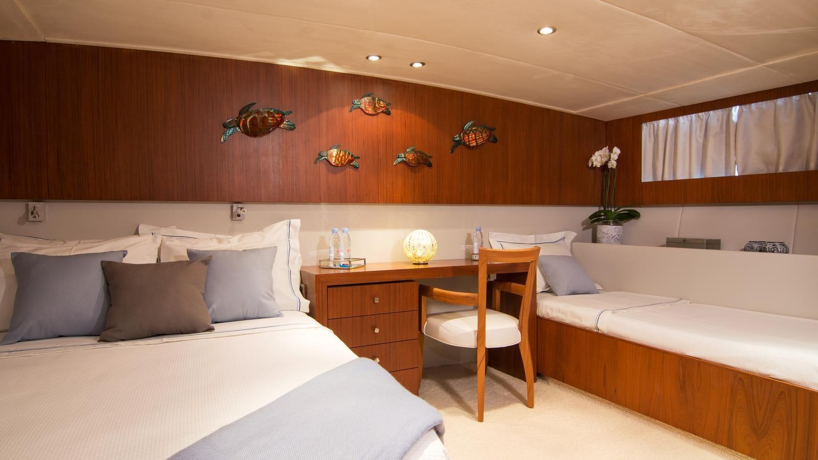 a room with a bed and a desk aboard OCEANE II Yacht for Sale