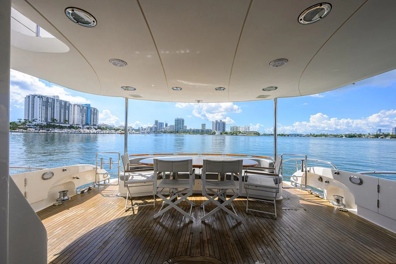 a deck with a view of a city and water aboard LIVING THE DREAM Yacht for Sale