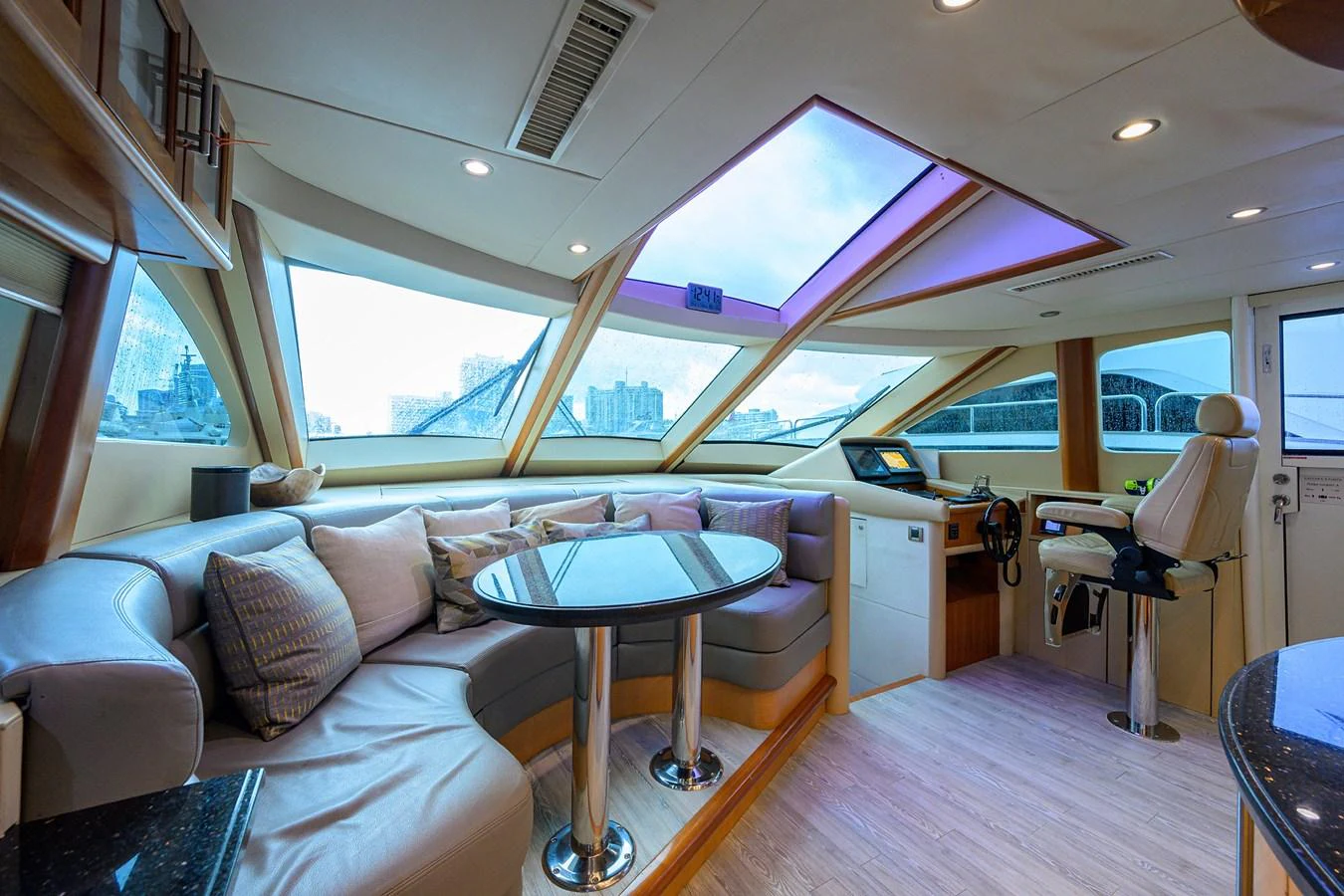 a living room with a large window aboard LIVING THE DREAM Yacht for Sale
