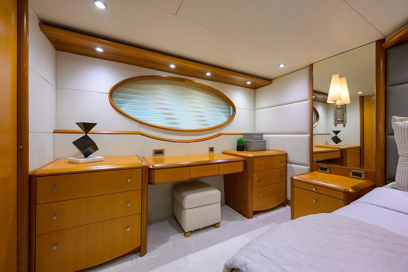 a bedroom with a large mirror above a bed aboard LIVING THE DREAM Yacht for Sale