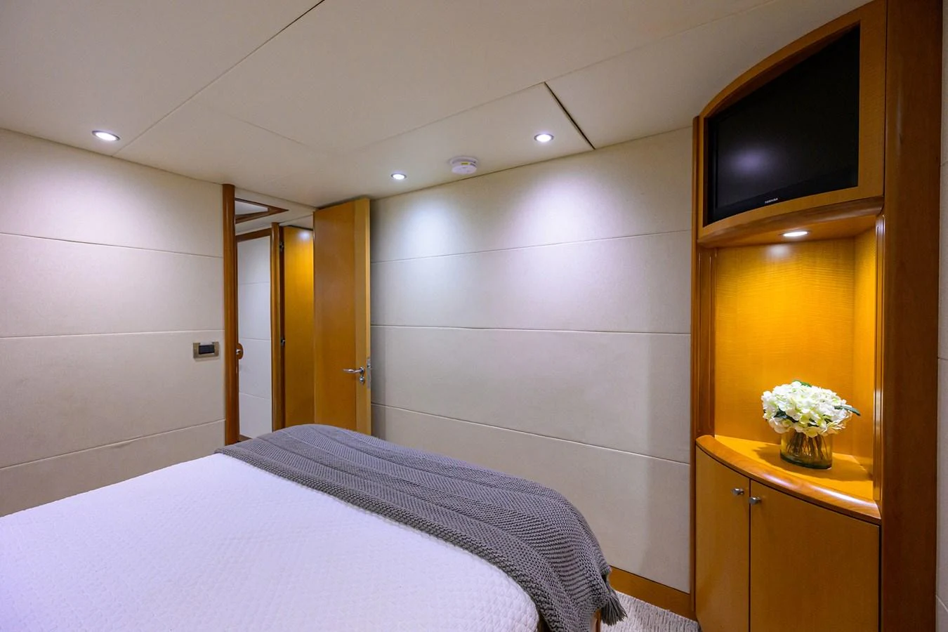 a bedroom with a tv and a bed aboard LIVING THE DREAM Yacht for Sale