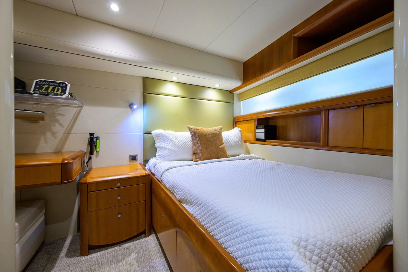 a bedroom with a bed and a desk aboard LIVING THE DREAM Yacht for Sale