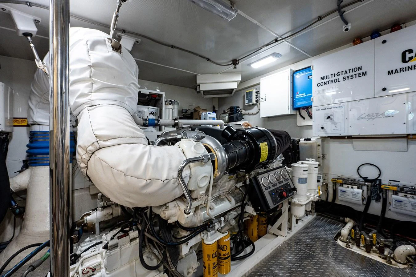 a person in a white suit working in a factory aboard LIVING THE DREAM Yacht for Sale