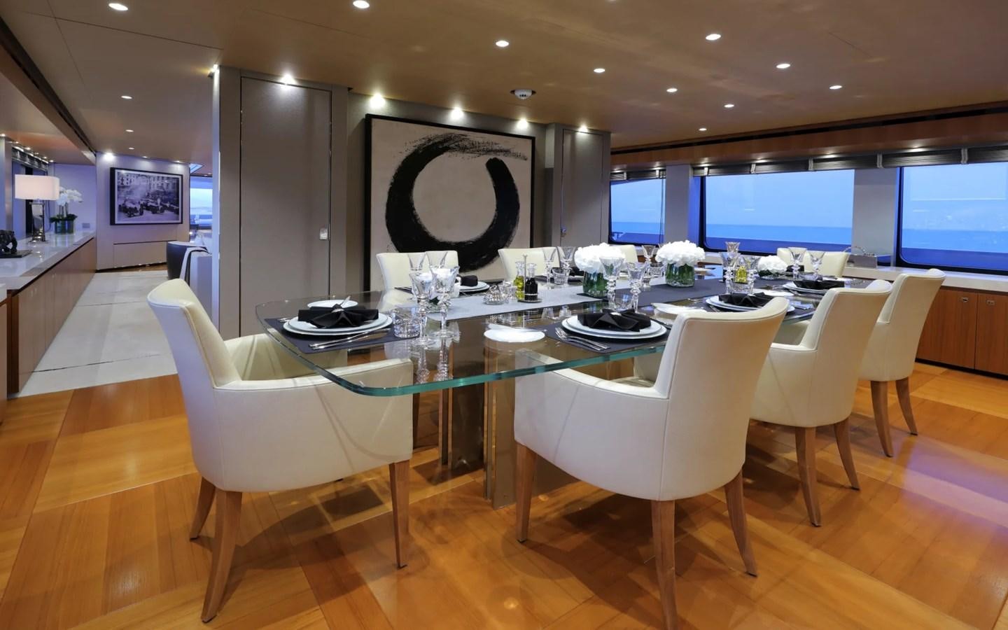 a large room with a table and chairs aboard MADO Yacht for Sale