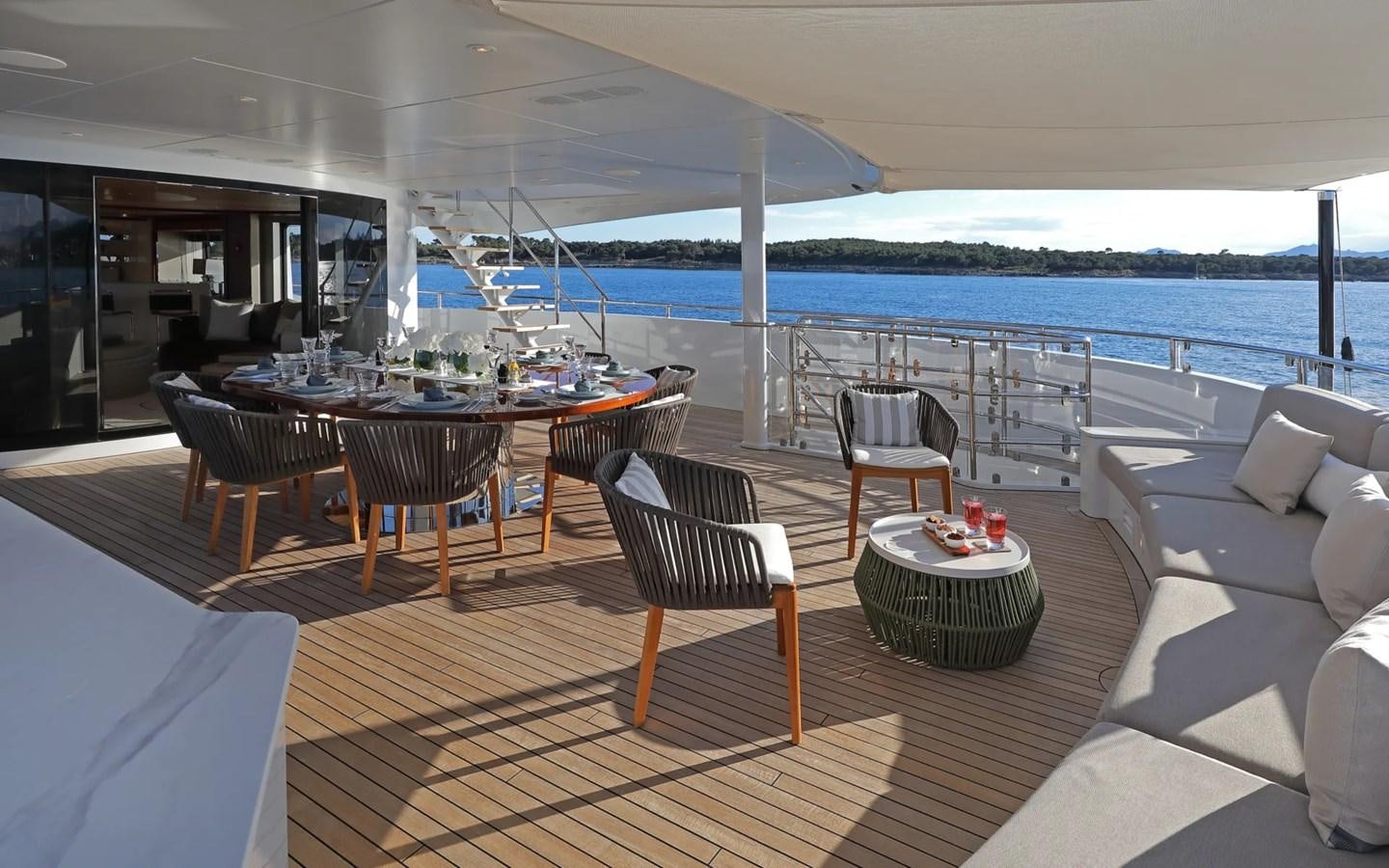 a room with a table and chairs aboard MADO Yacht for Sale