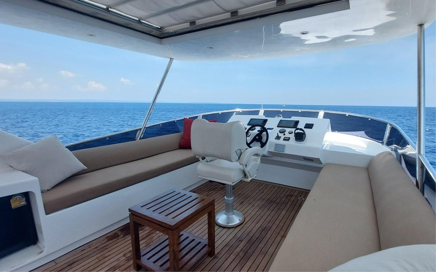 a boat with a deck and a table and chairs on it aboard ONEIRONAUT Yacht for Sale
