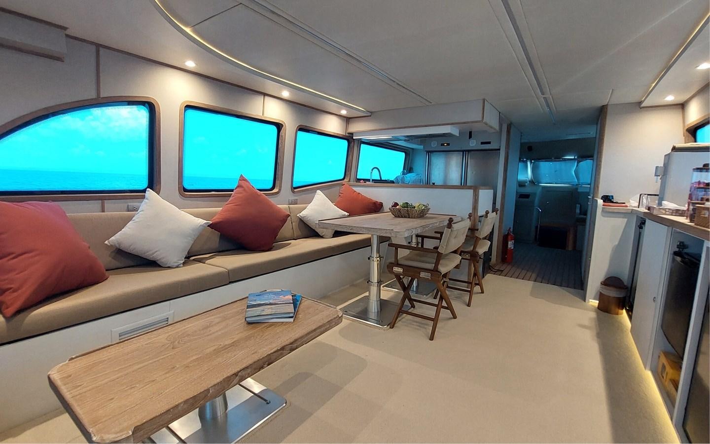 a room with a couch and a table and chairs aboard ONEIRONAUT Yacht for Sale