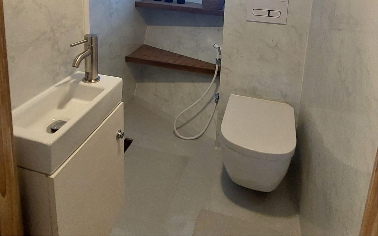 a bathroom with a toilet and sink aboard ONEIRONAUT Yacht for Sale