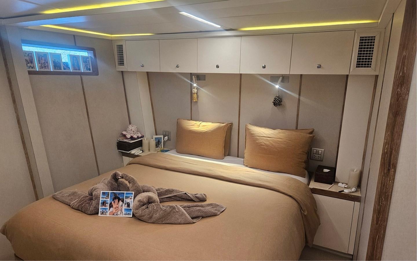 a person lying on a bed aboard ONEIRONAUT Yacht for Sale