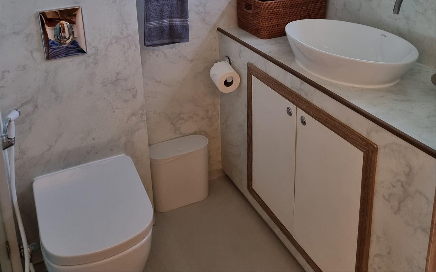 a bathroom with a toilet and a sink aboard ONEIRONAUT Yacht for Sale