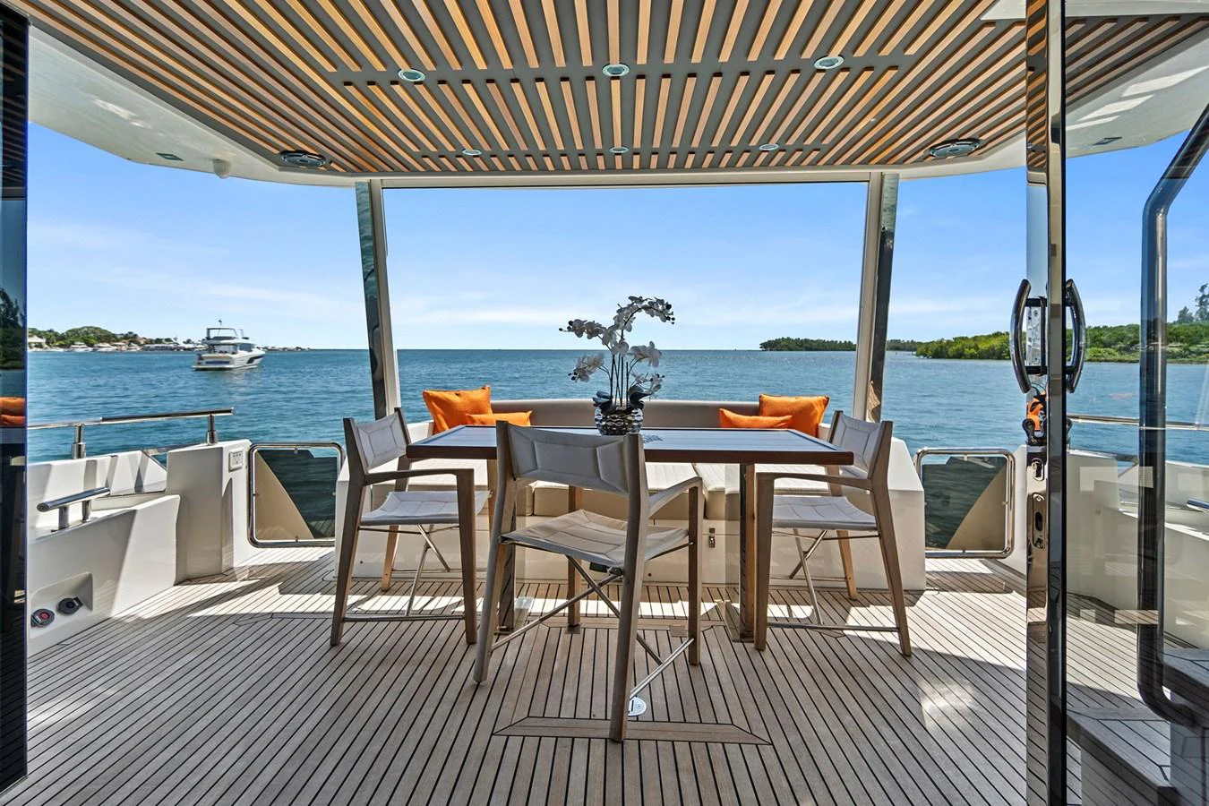 a table and chairs on a deck aboard SMILE Yacht for Sale