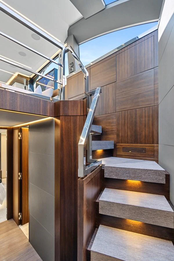a room with wooden floors and a staircase aboard SMILE Yacht for Sale