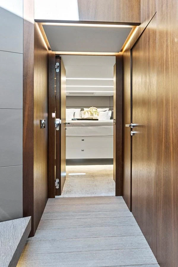 a room with a wood door and a wood floor aboard SMILE Yacht for Sale