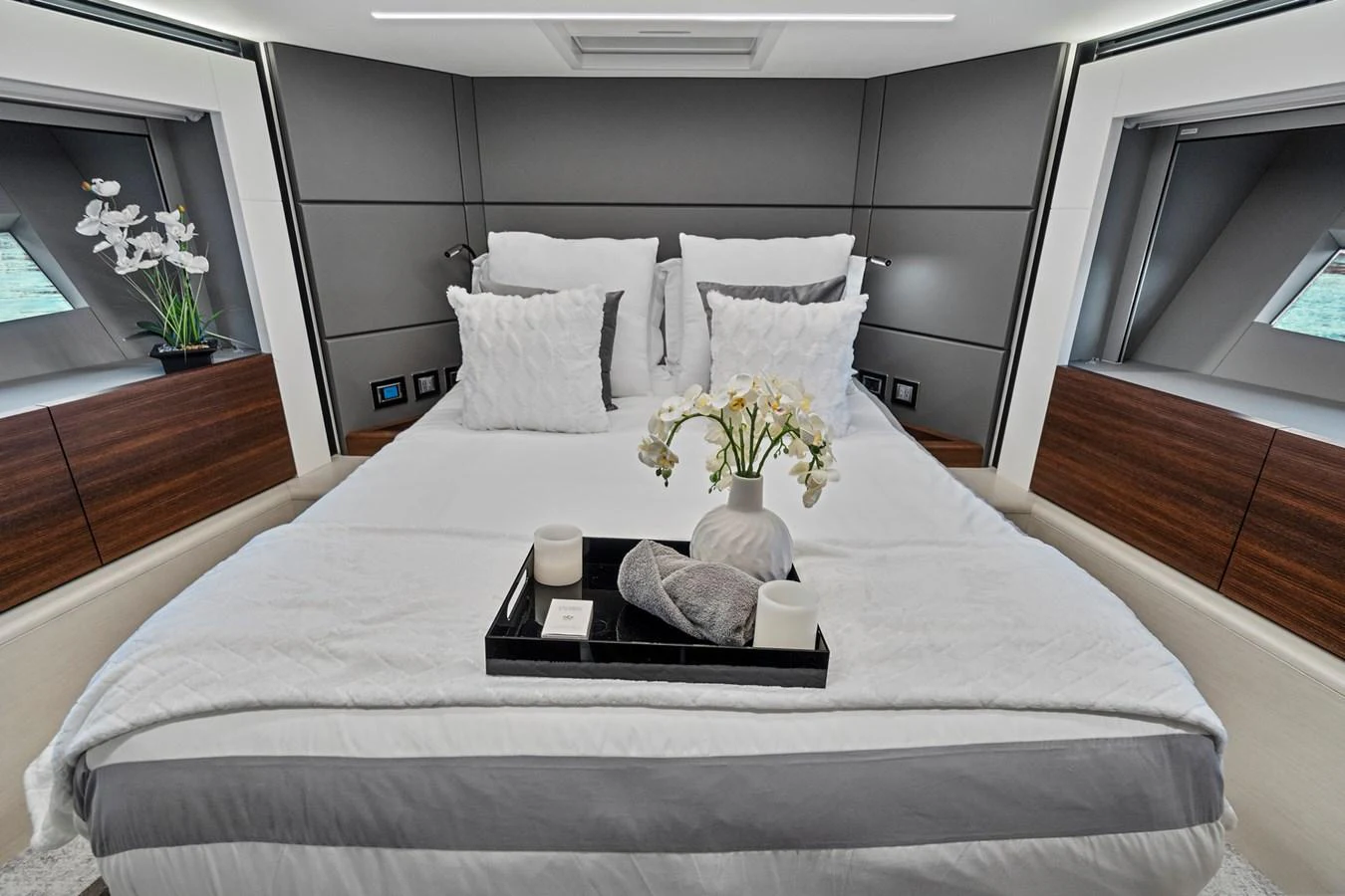 a bed with white sheets and pillows aboard SMILE Yacht for Sale