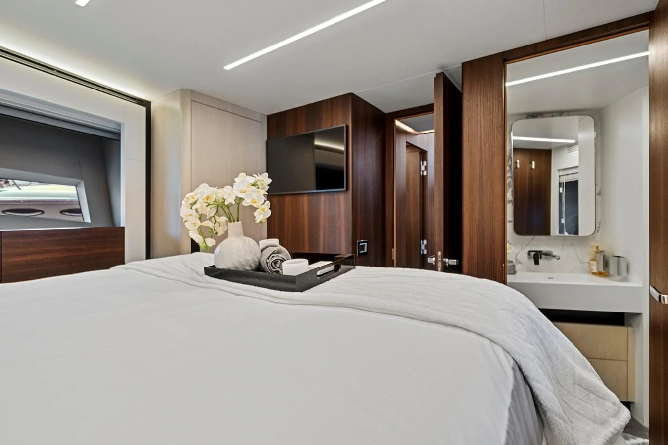 a bed with white sheets and pillows aboard SMILE Yacht for Sale