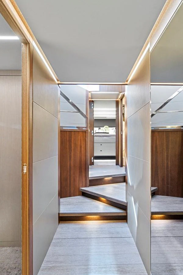 a long hallway with wooden doors aboard SMILE Yacht for Sale