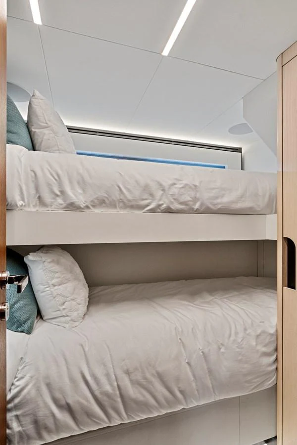 a bed with white sheets aboard SMILE Yacht for Sale