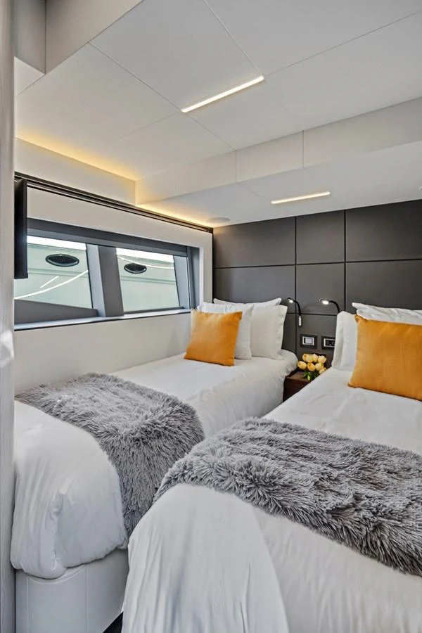 a room with two beds aboard SMILE Yacht for Sale