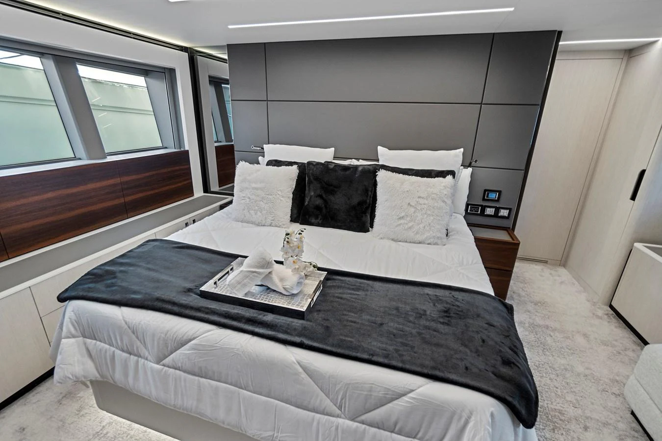 a bed with a black and white bed spread aboard SMILE Yacht for Sale