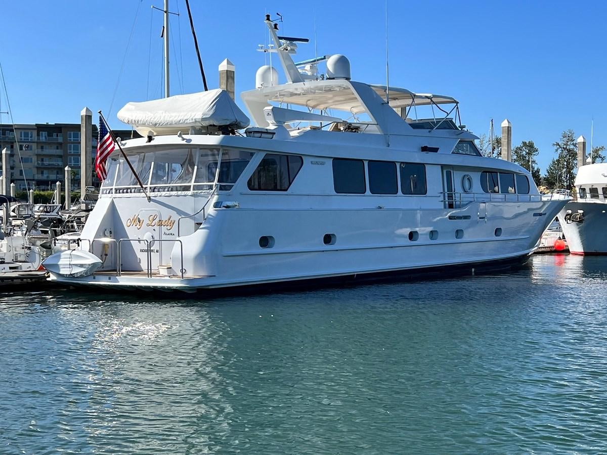 a large white boat in a harbor aboard 2001 BROWARD RAISED PILOTHOUSE MY Yacht for Sale