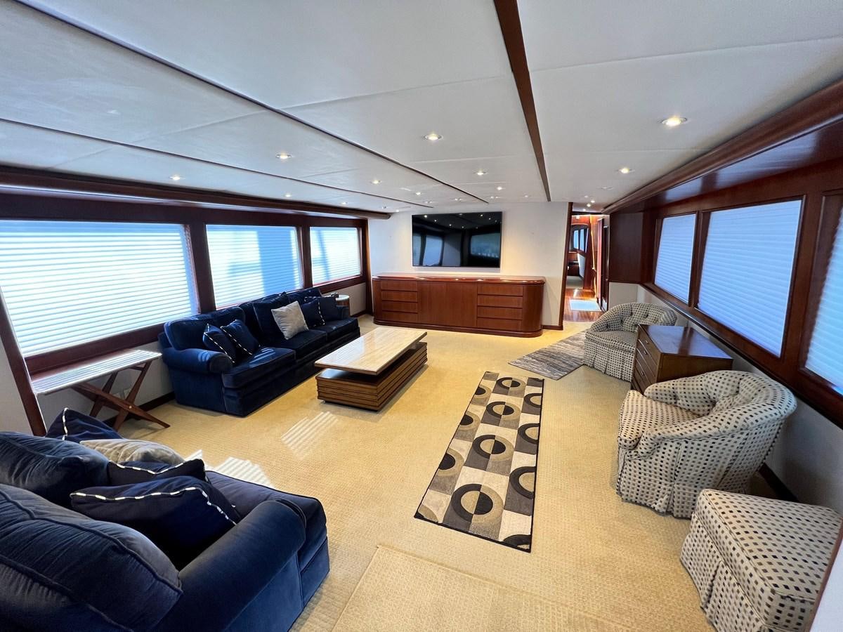 a living room with a large window aboard 2001 BROWARD RAISED PILOTHOUSE MY Yacht for Sale
