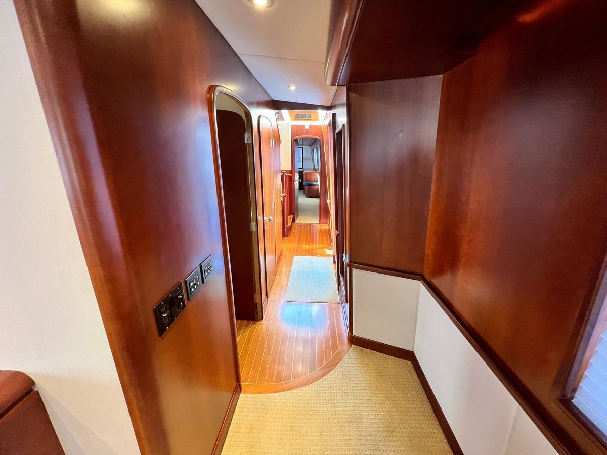 a hallway with a door and a hallway aboard 2001 BROWARD RAISED PILOTHOUSE MY Yacht for Sale