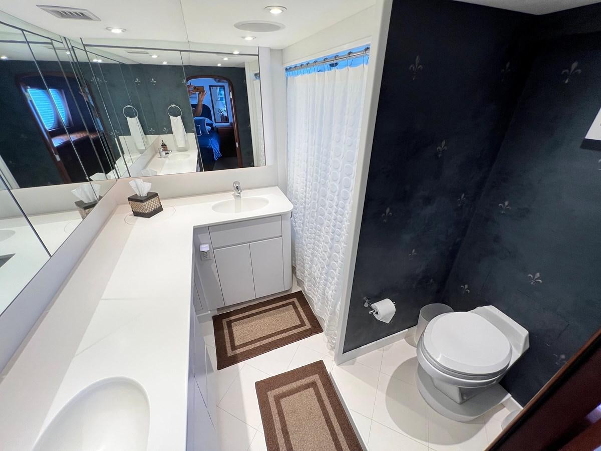 a bathroom with a toilet and a sink aboard 2001 BROWARD RAISED PILOTHOUSE MY Yacht for Sale