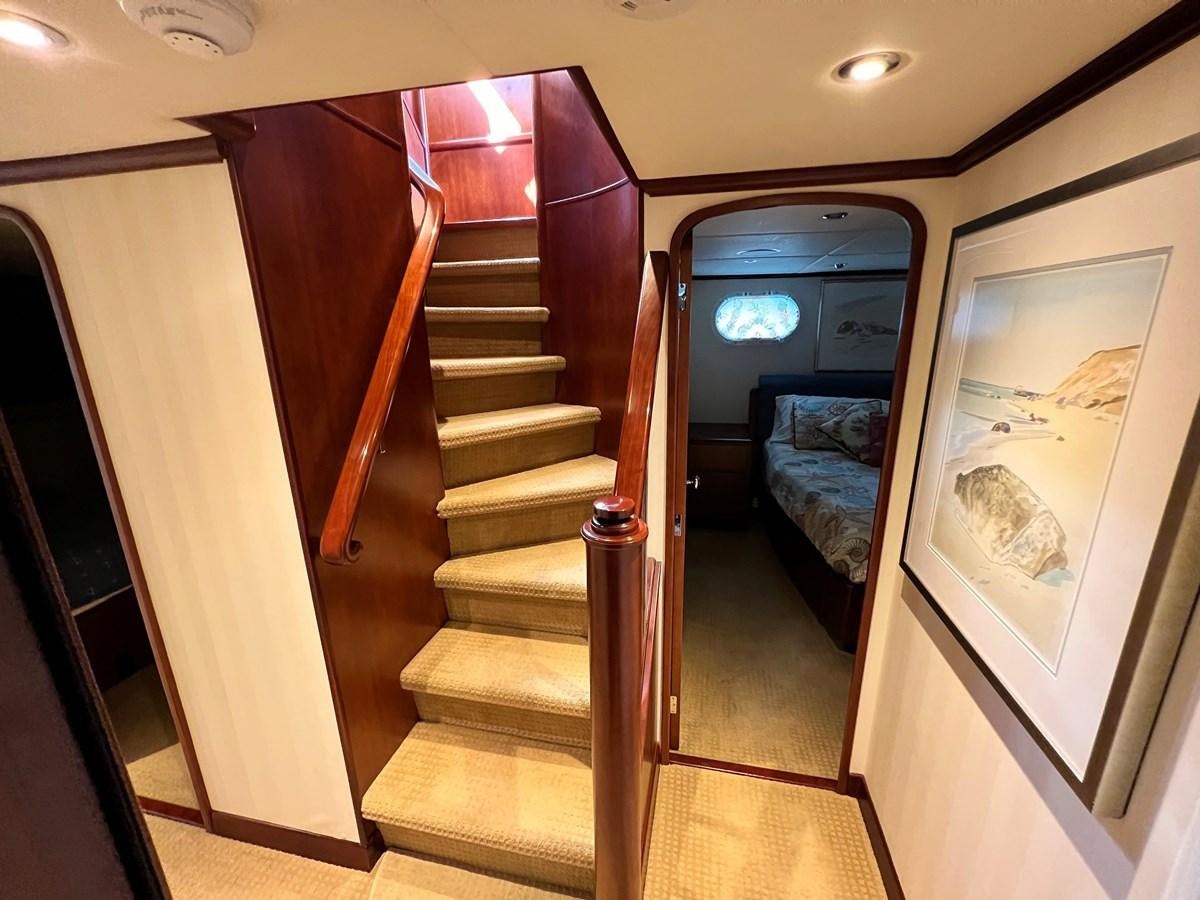 a set of stairs leading to a bedroom aboard 2001 BROWARD RAISED PILOTHOUSE MY Yacht for Sale