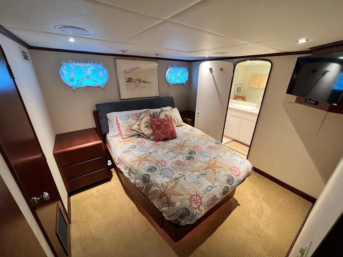 a bed in a room aboard 2001 BROWARD RAISED PILOTHOUSE MY Yacht for Sale