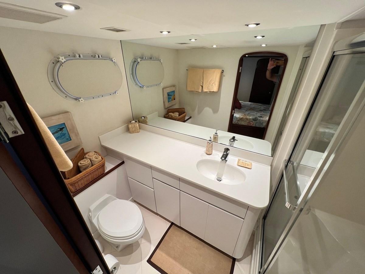 a bathroom with a toilet and a sink aboard 2001 BROWARD RAISED PILOTHOUSE MY Yacht for Sale