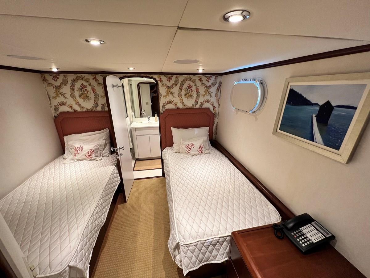 a hotel room with two beds aboard 2001 BROWARD RAISED PILOTHOUSE MY Yacht for Sale