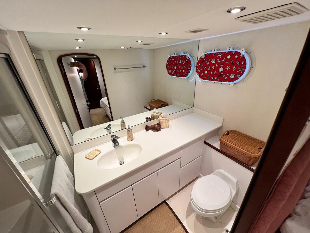 a bathroom with a large mirror aboard 2001 BROWARD RAISED PILOTHOUSE MY Yacht for Sale
