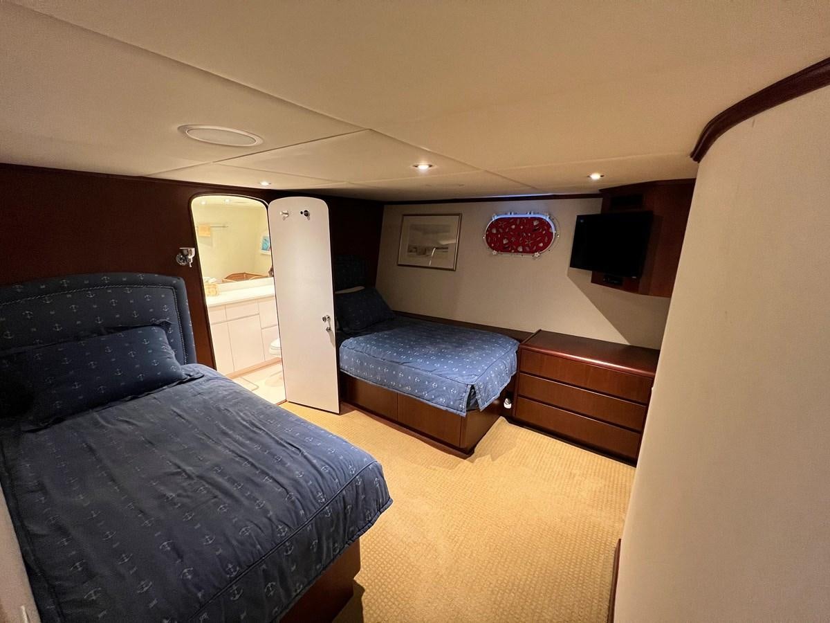 a room with a couch and a television aboard 2001 BROWARD RAISED PILOTHOUSE MY Yacht for Sale