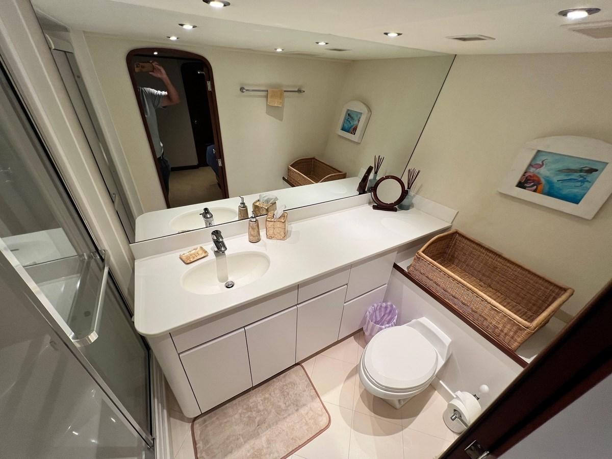 a bathroom with a large mirror aboard 2001 BROWARD RAISED PILOTHOUSE MY Yacht for Sale