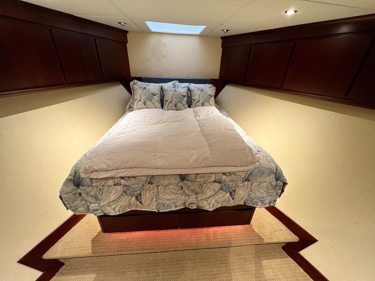 a bed with white sheets aboard 2001 BROWARD RAISED PILOTHOUSE MY Yacht for Sale