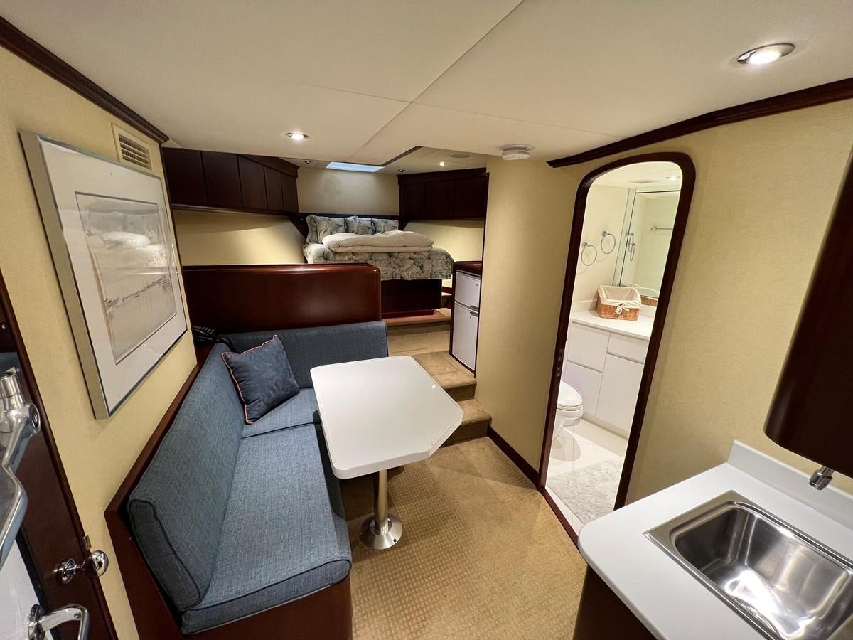 a hotel room with a bed and a sink aboard 2001 BROWARD RAISED PILOTHOUSE MY Yacht for Sale