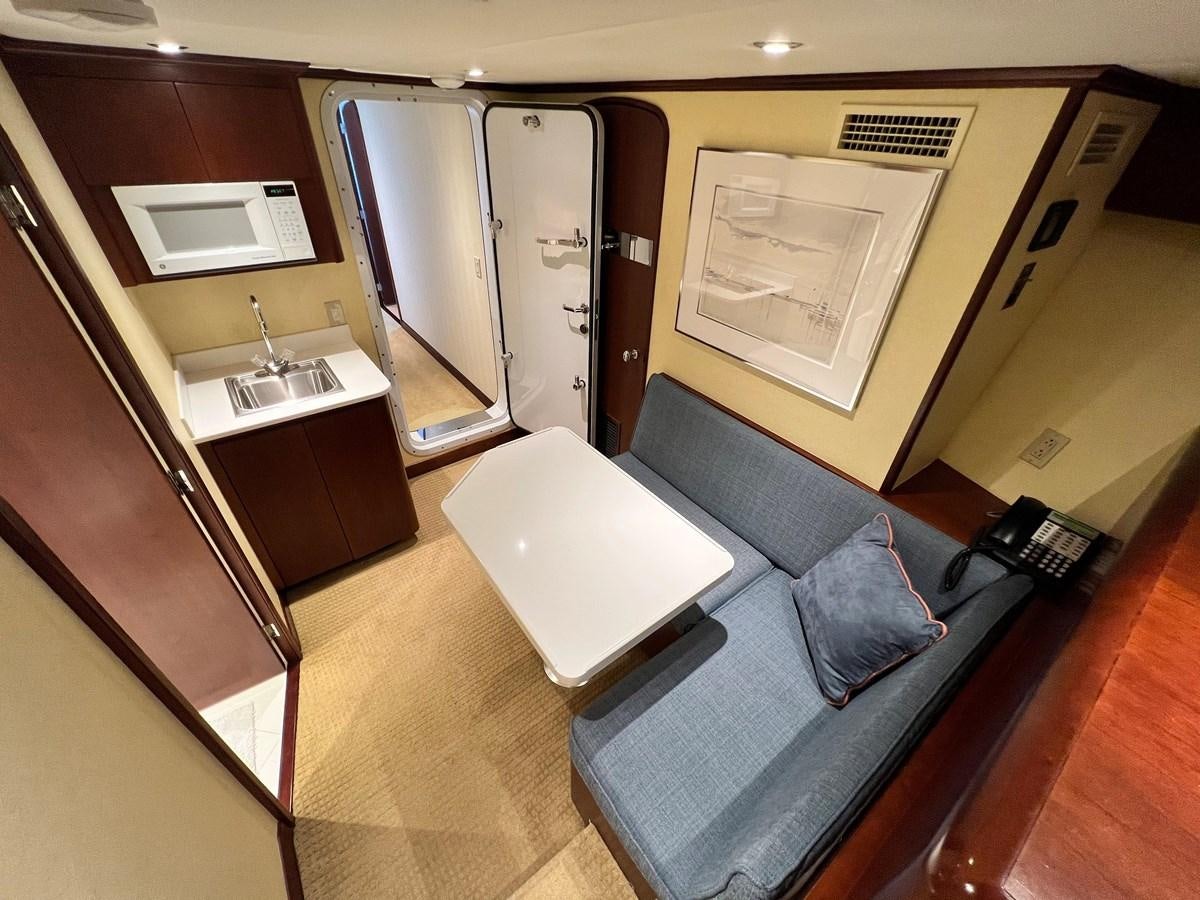 a room with a couch and a table aboard 2001 BROWARD RAISED PILOTHOUSE MY Yacht for Sale