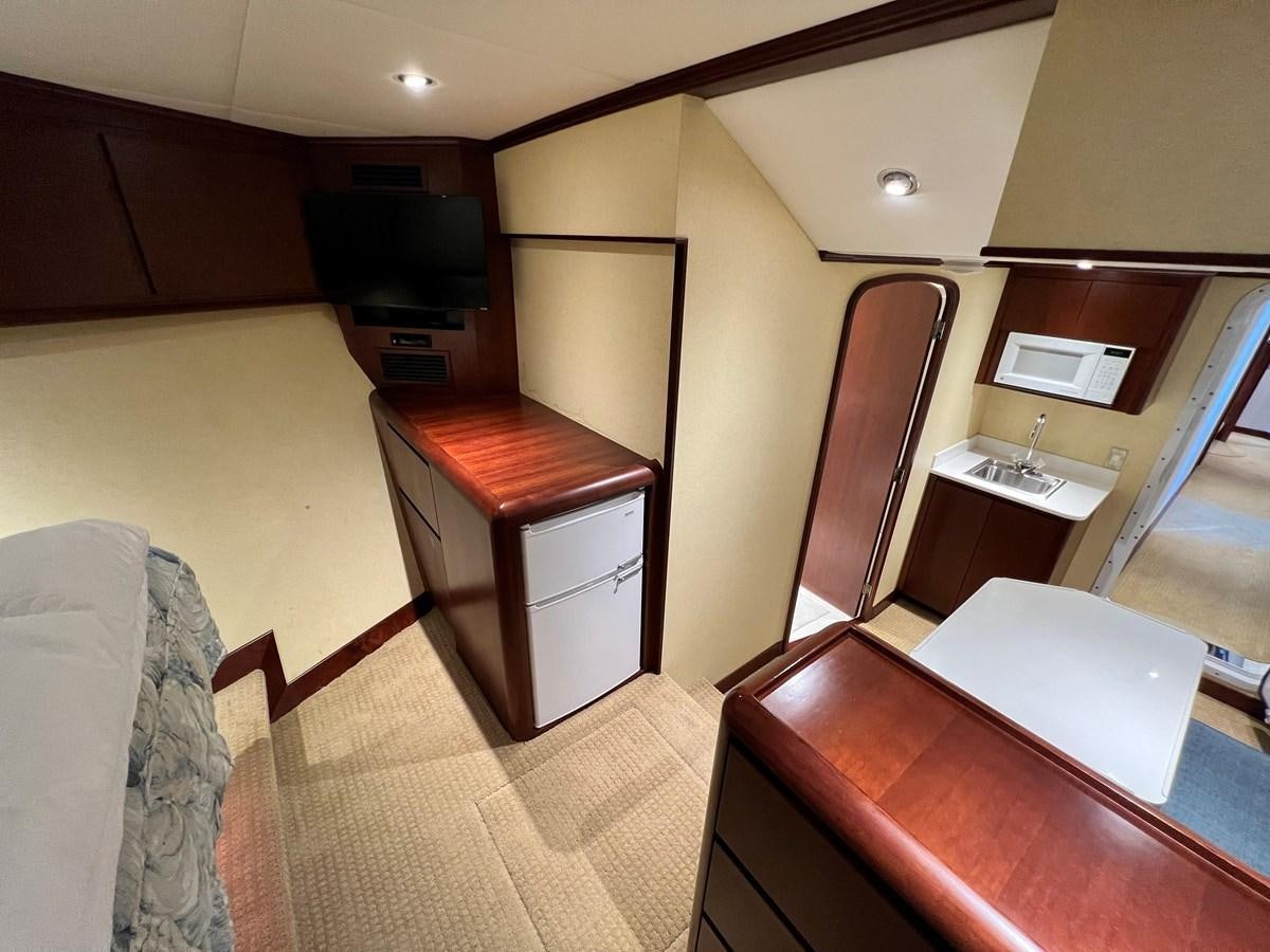 a room with a desk and a tv aboard 2001 BROWARD RAISED PILOTHOUSE MY Yacht for Sale