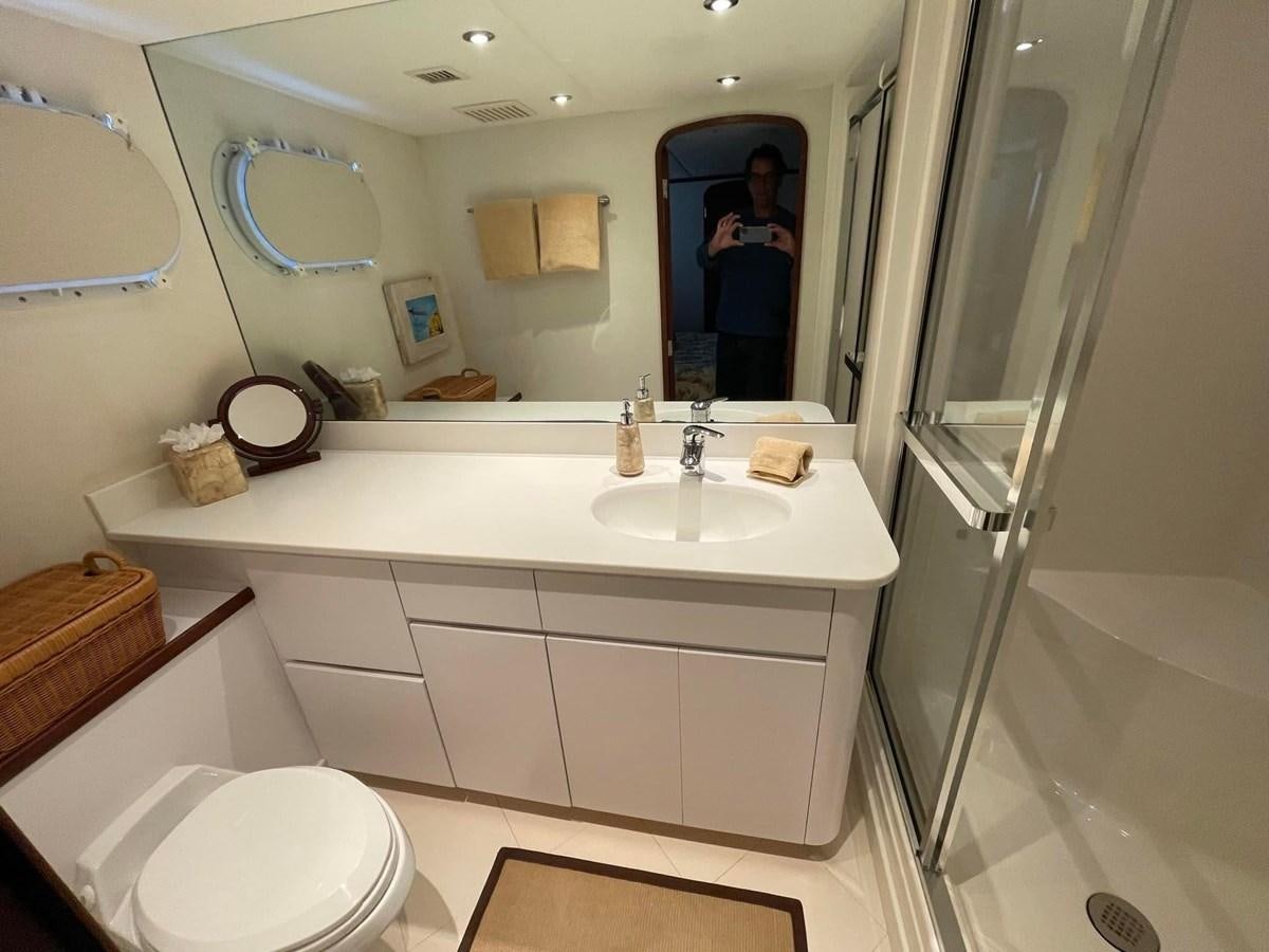 a bathroom with a large mirror aboard 2001 BROWARD RAISED PILOTHOUSE MY Yacht for Sale