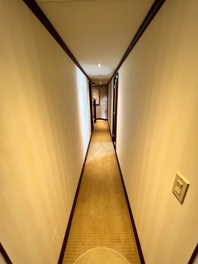a long hallway with a light on aboard 2001 BROWARD RAISED PILOTHOUSE MY Yacht for Sale