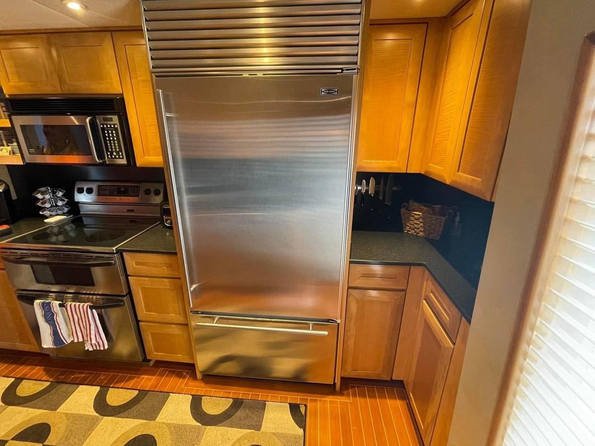 a kitchen with a stainless steel oven aboard 2001 BROWARD RAISED PILOTHOUSE MY Yacht for Sale