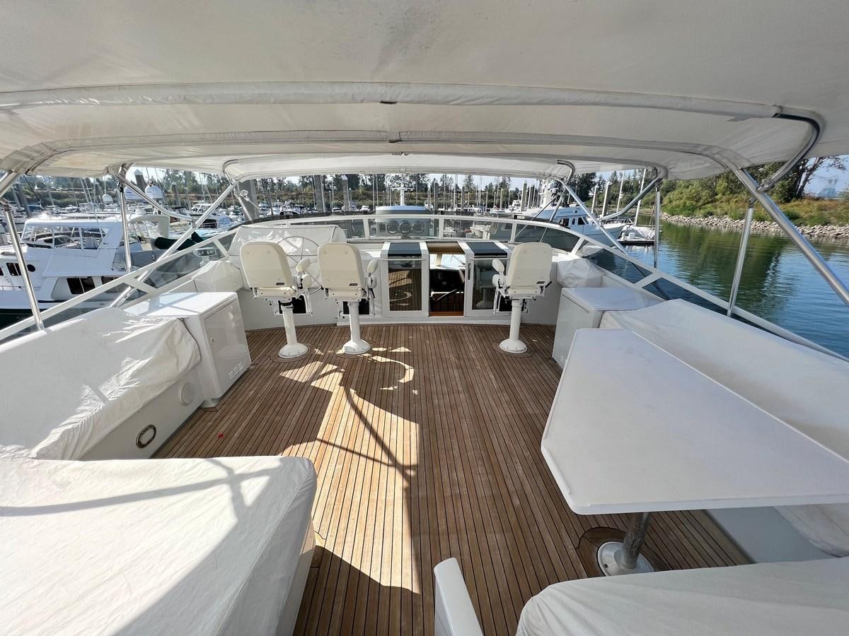 a deck with a deck and chairs on it aboard 2001 BROWARD RAISED PILOTHOUSE MY Yacht for Sale